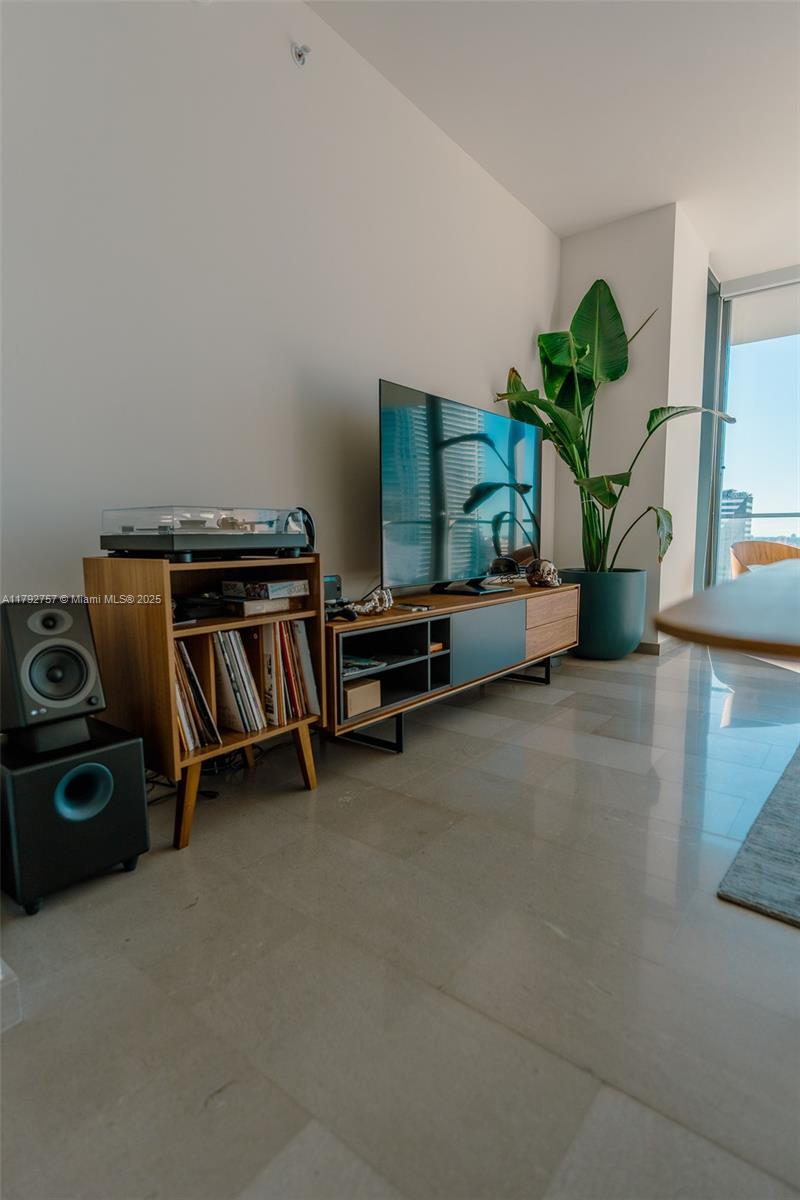 68 Southeast 6th Street, Unit 1204 Miami, FL 33131 - Photo 27 of 48 a living room with furniture and a potted plant
