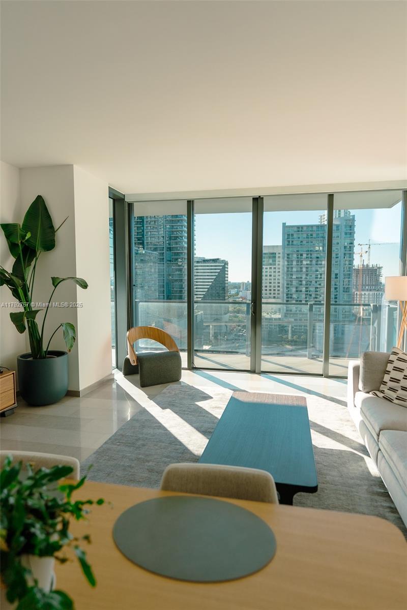 68 Southeast 6th Street, Unit 1204 Miami, FL 33131 - Photo 9 of 48 a living room with furniture and a large window