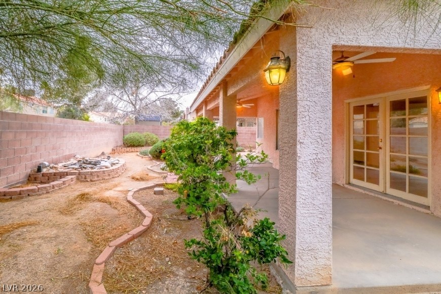 1429 Hawkwood Road Henderson, NV 89014 - Photo 40 of 53 A spacious covered patio overlooks the enclosed backyard featuring brick-bordered garden beds.