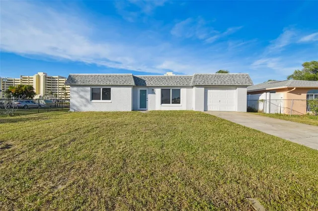 a view of a house with yard and sitting area