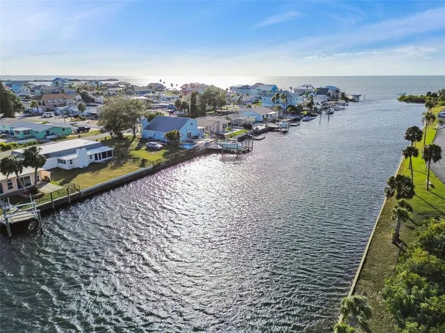 a view of residential houses with yard and ocean view