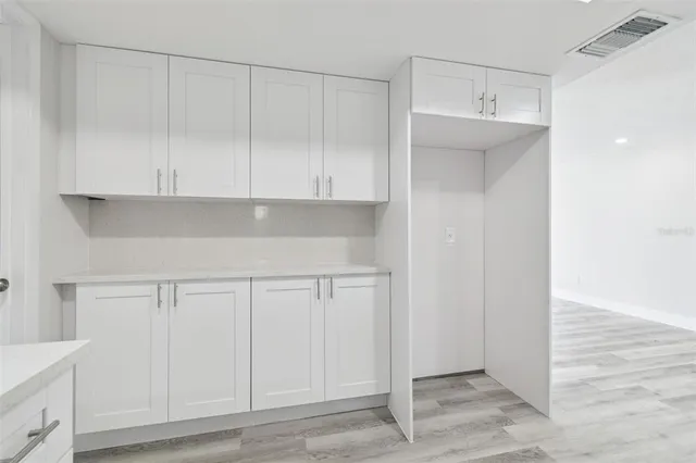 a view of cabinets and wooden floor