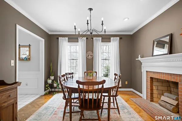a kitchen with stainless steel appliances granite countertop a stove a refrigerator a kitchen island a sink a stove a dining table and chairs