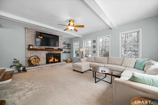 a living room with furniture and a fireplace