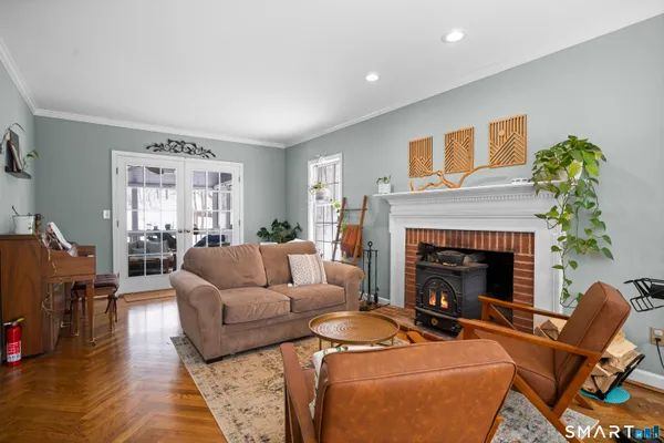 a bedroom with a bed couch and a window