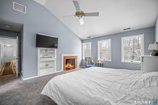 a bedroom with furniture and a wooden floor