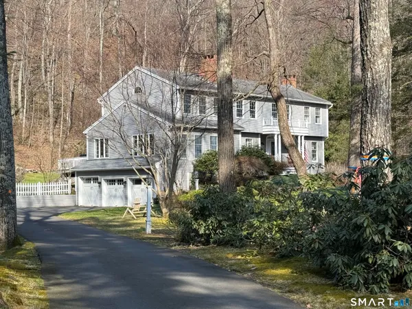 a front view of a house with a yard and potted plants