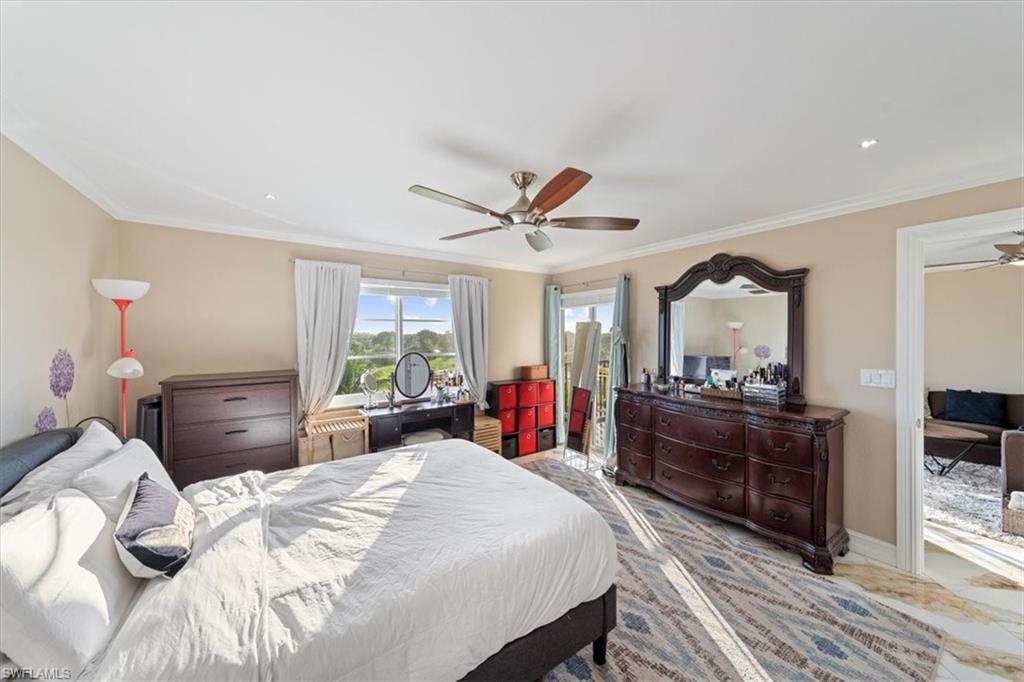 190 Pebble Beach Boulevard, Unit 502 Naples, FL 34113 - Photo 15 of 27 a bed room with a bed and a large mirror