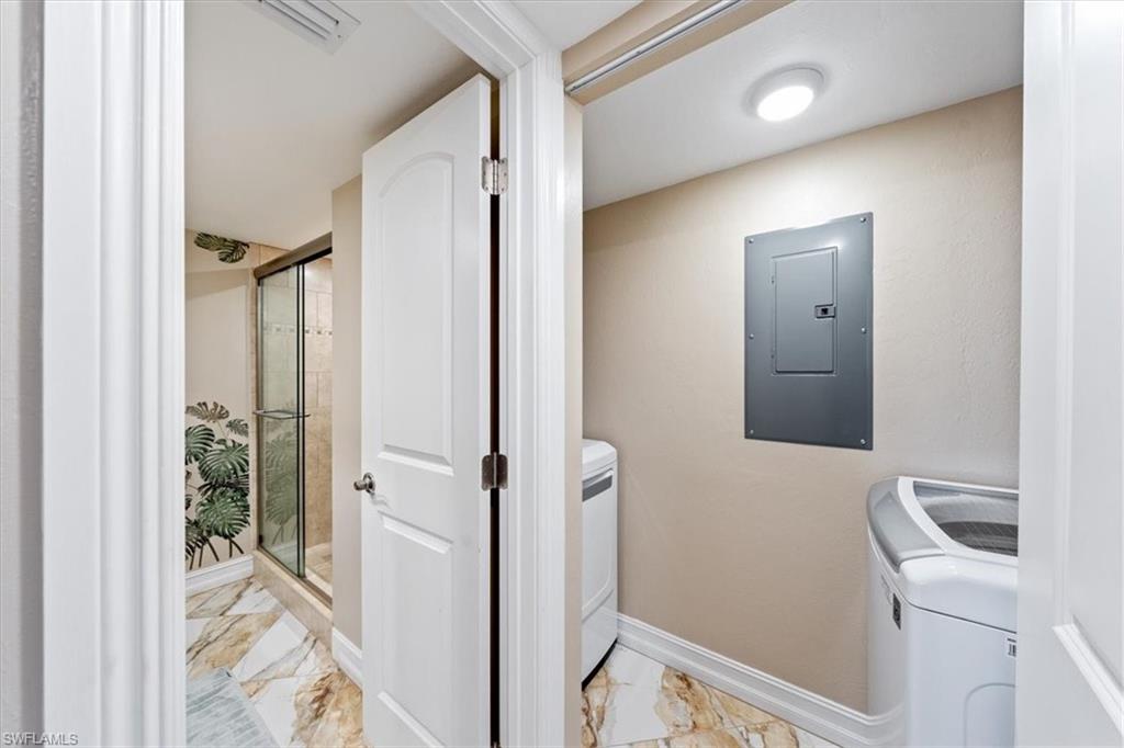 190 Pebble Beach Boulevard, Unit 502 Naples, FL 34113 - Photo 21 of 27 a bathroom with a sink and glass door
