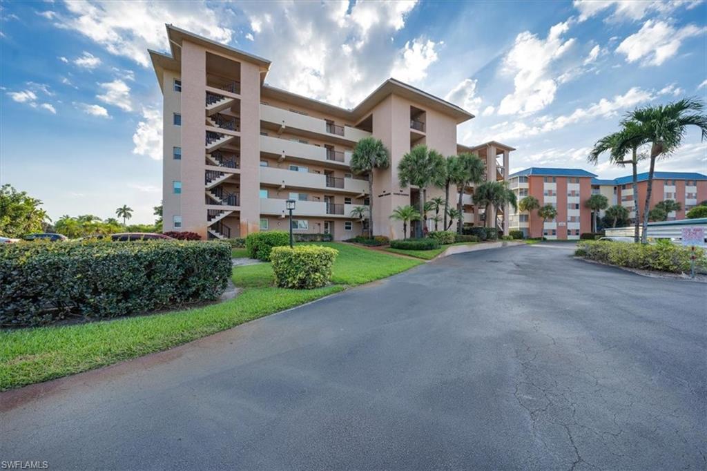 190 Pebble Beach Boulevard, Unit 502 Naples, FL 34113 - Photo 25 of 27 a view of a street with a building in the background