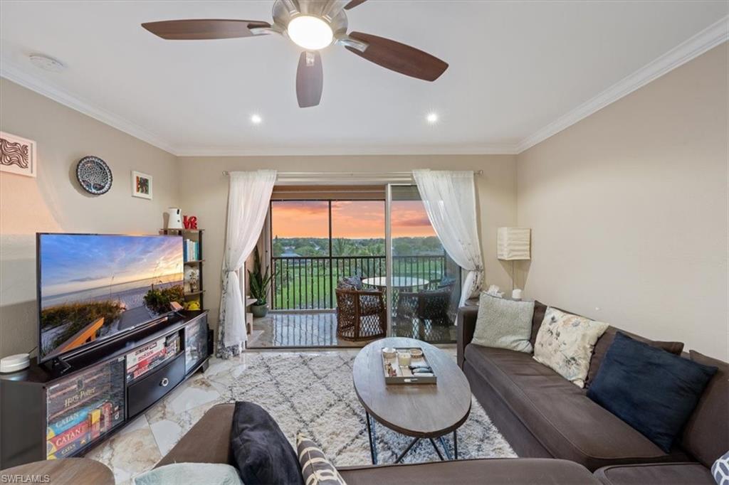 190 Pebble Beach Boulevard, Unit 502 Naples, FL 34113 - Photo 3 of 27 a living room with furniture and a flat screen tv