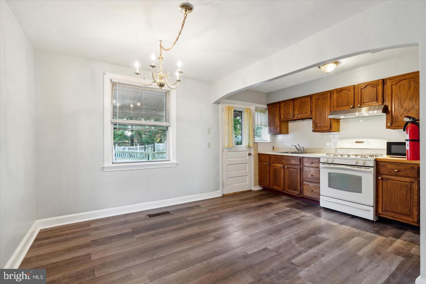 620 MacDade Boulevard Darby, PA 19023 - Photo 5 of 23 a kitchen with granite countertop white cabinets and white appliances