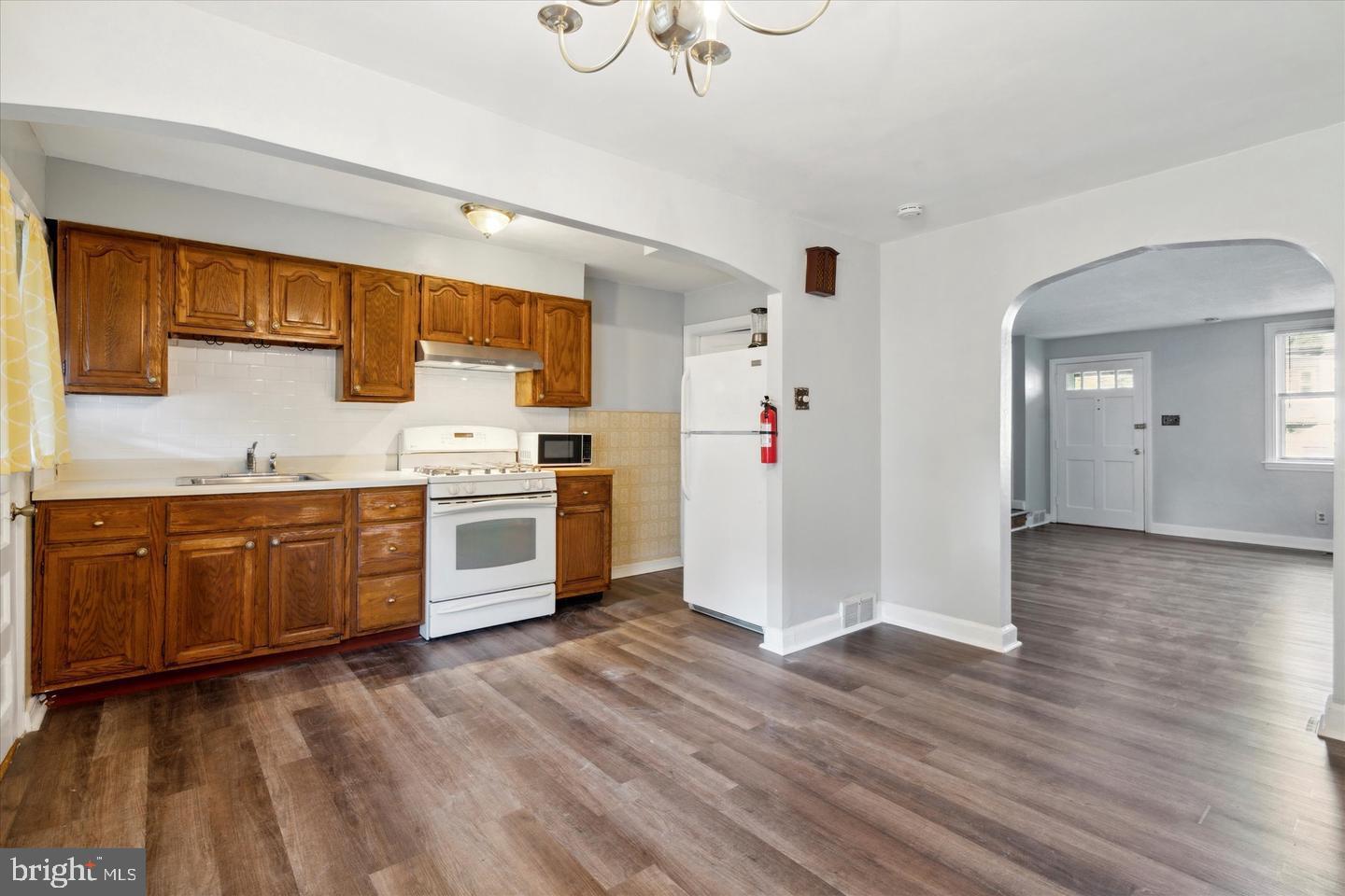 620 MacDade Boulevard Darby, PA 19023 - Photo 6 of 23 a kitchen with a white cabinets and white appliances