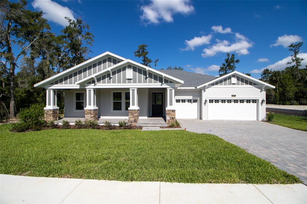 a front view of a house with garden and porch