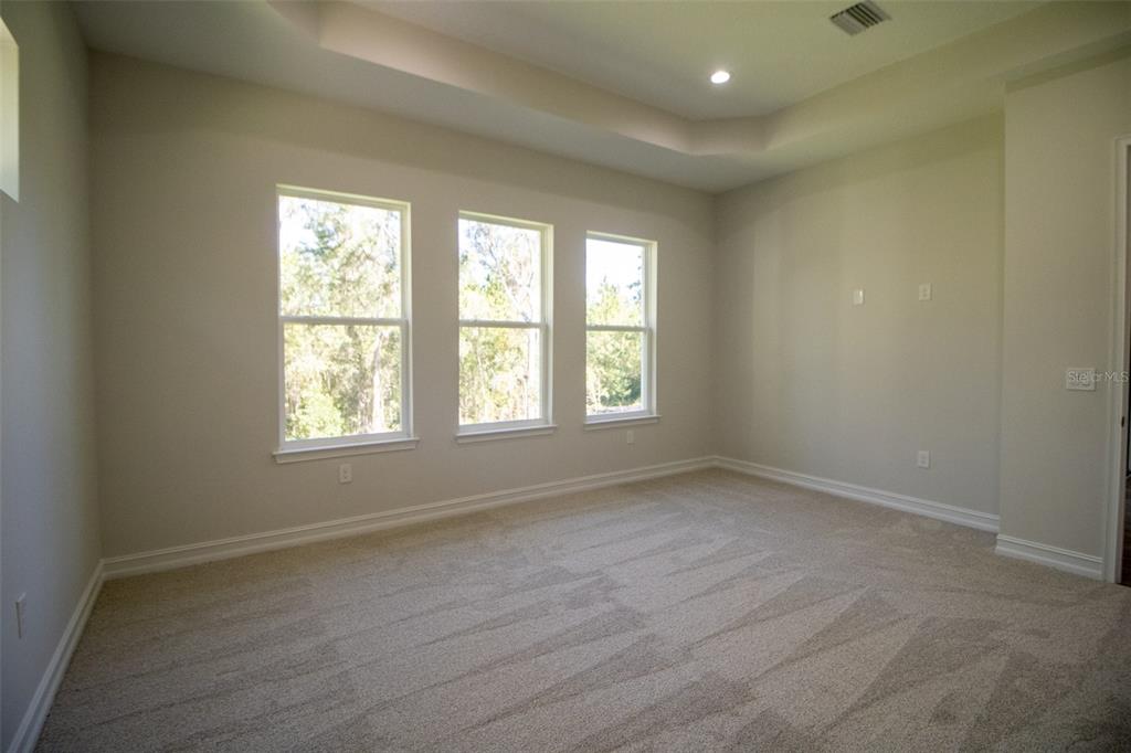 6671 Summit View Drive Brooksville, FL 34601 - Photo 15 of 37 an empty room with wooden floor and windows