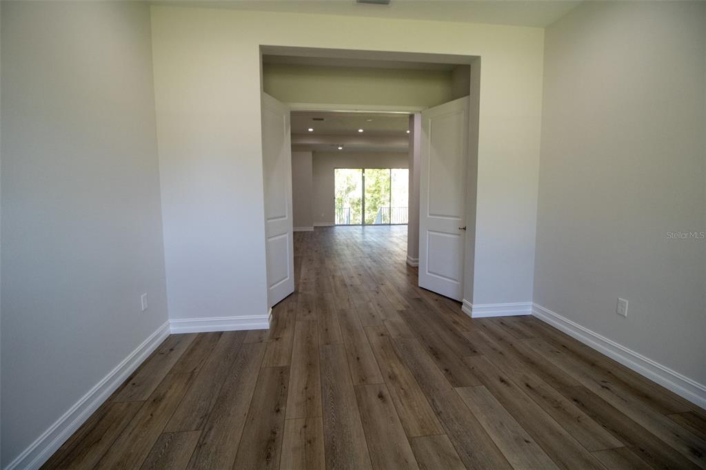 6671 Summit View Drive Brooksville, FL 34601 - Photo 22 of 37 a view of a hallway with wooden floor