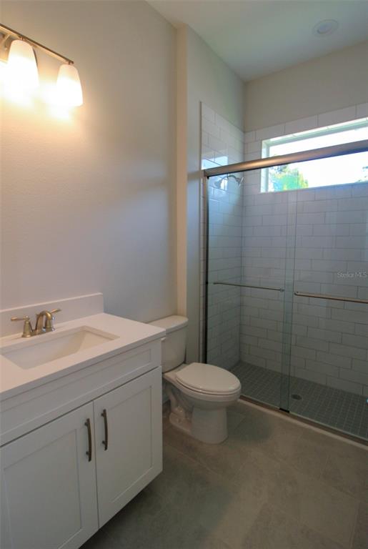 6671 Summit View Drive Brooksville, FL 34601 - Photo 27 of 37 a bathroom with a sink a toilet and shower