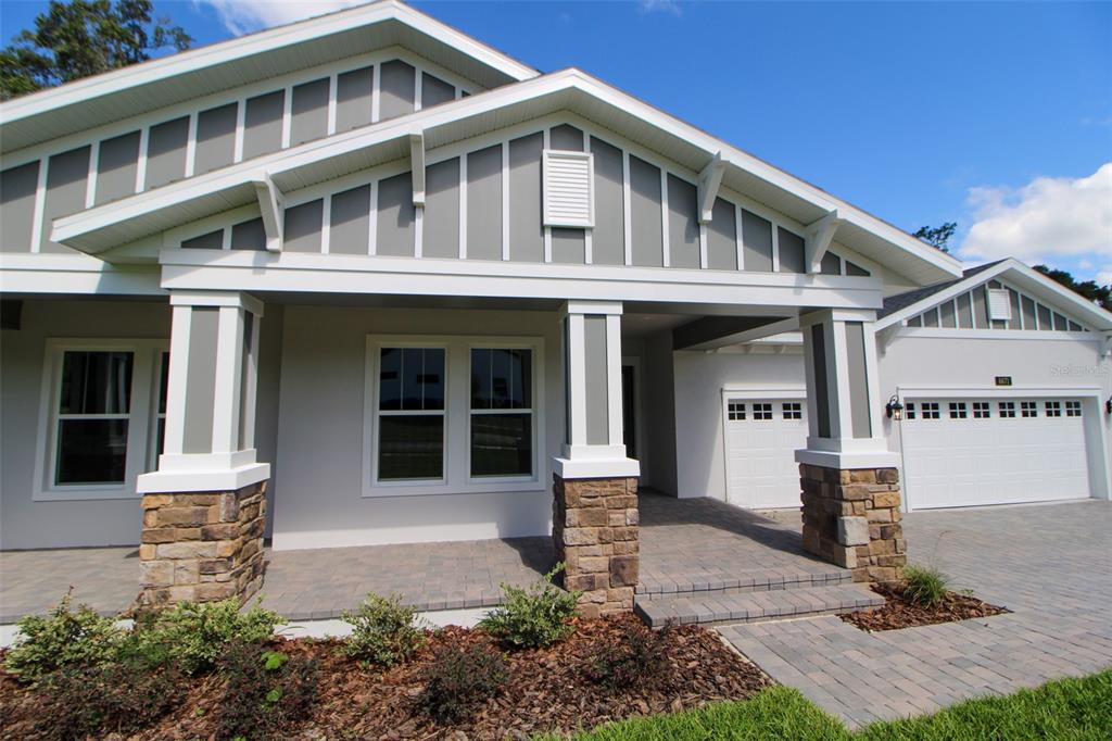 6671 Summit View Drive Brooksville, FL 34601 - Photo 5 of 37 a front view of a house with garden