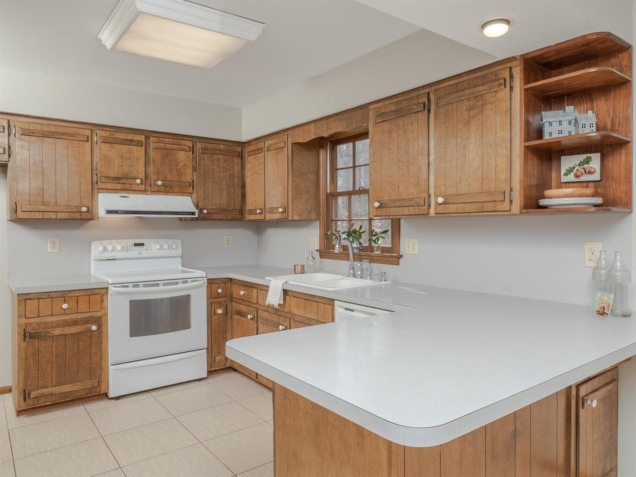 8317 Druids Lane Raleigh, NC 27613 - Photo 10 of 24 Kitchen has plenty of storage and great views to the backyard. Kitchen
