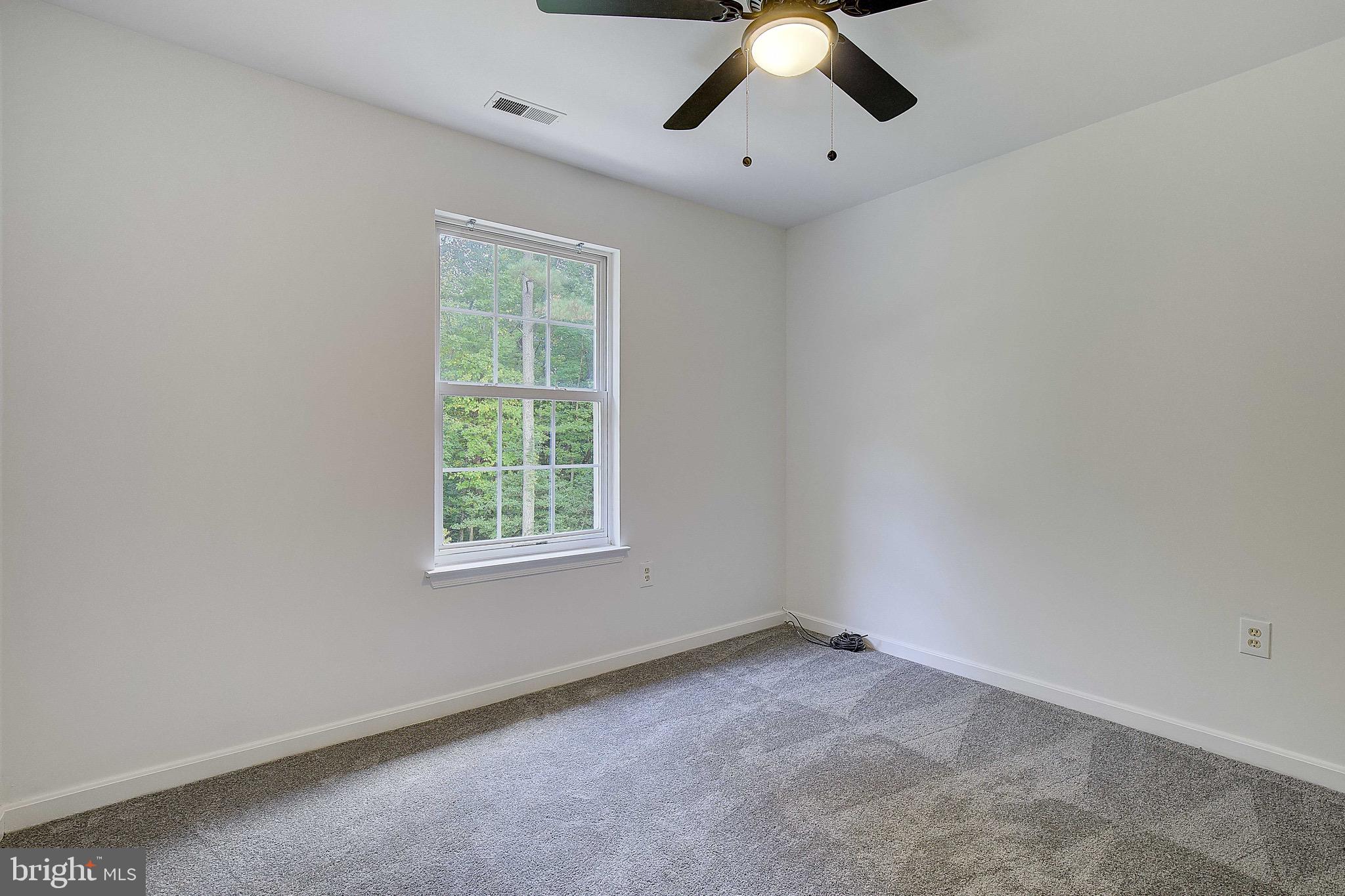 721 Small Reward Road Huntingtown, MD 20639 - Photo 24 of 51 an empty room with a window