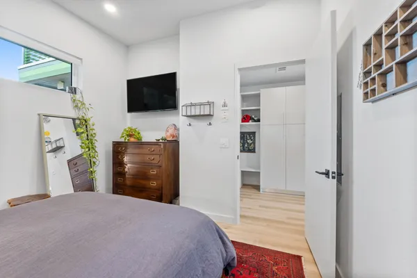 a bedroom with a bed and a flat screen tv