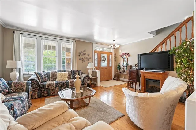 a living room with furniture a flat screen tv and a large window