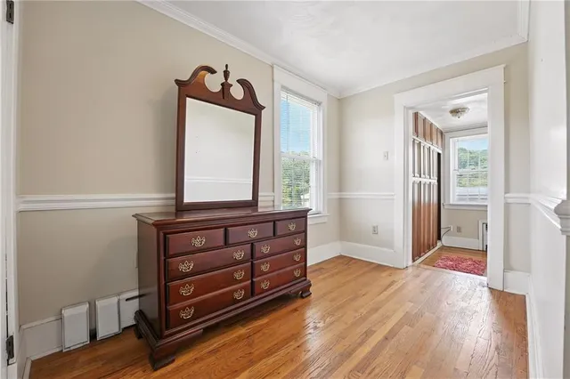 a view of room with wooden floor and cabinet
