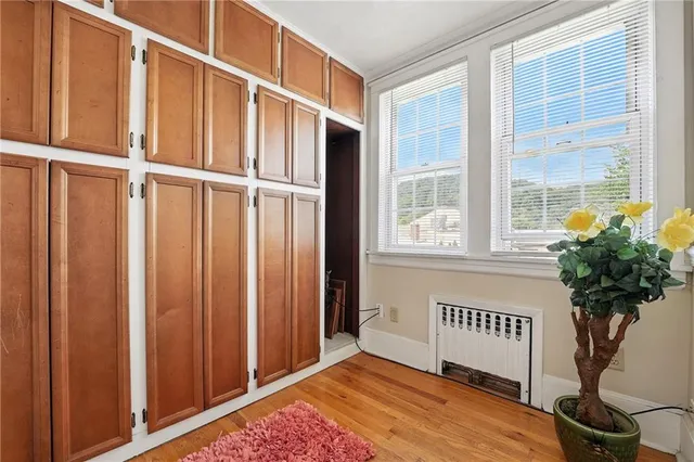 a view of a porch with wooden floor and a potted plant