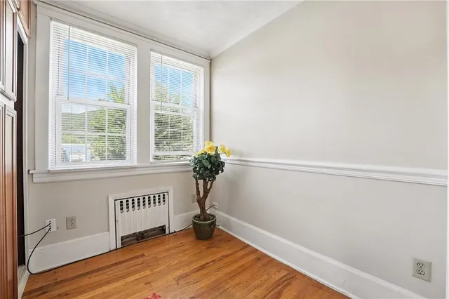 a view of a room with a window and wooden floor