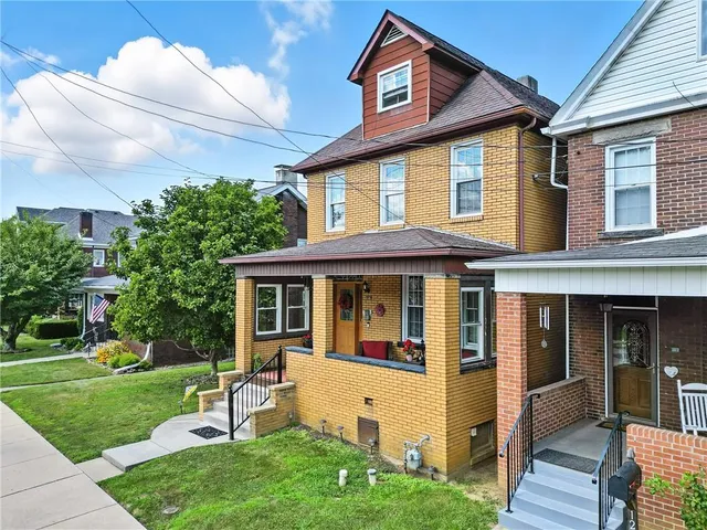 a view of a house with a yard and sitting area