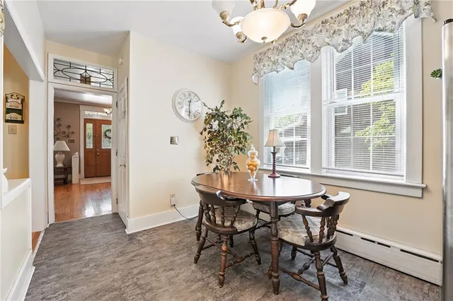 a view of a dining room with furniture and chandelier