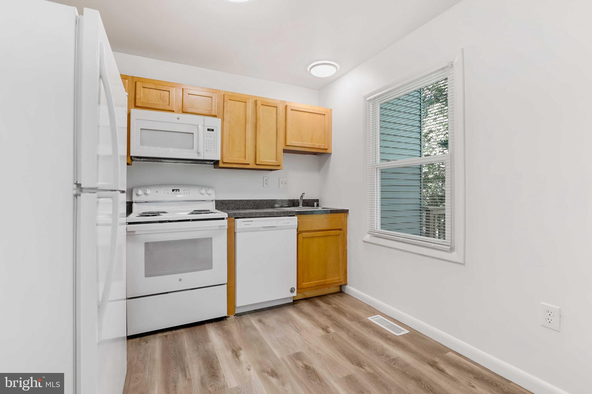 1634 Mt Airy Court Crofton, MD 21114 - Photo 11 of 40 a kitchen with stainless steel appliances a stove a sink and a microwave