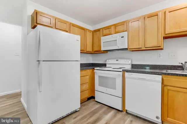 a kitchen with stainless steel appliances granite countertop a refrigerator sink and cabinets