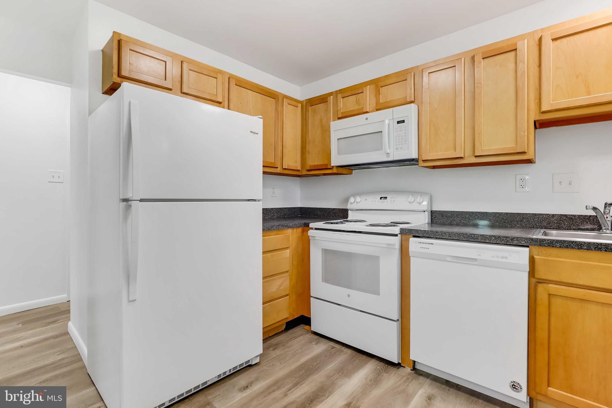 1634 Mt Airy Court Crofton, MD 21114 - Photo 12 of 40 a kitchen with stainless steel appliances granite countertop a refrigerator sink and cabinets