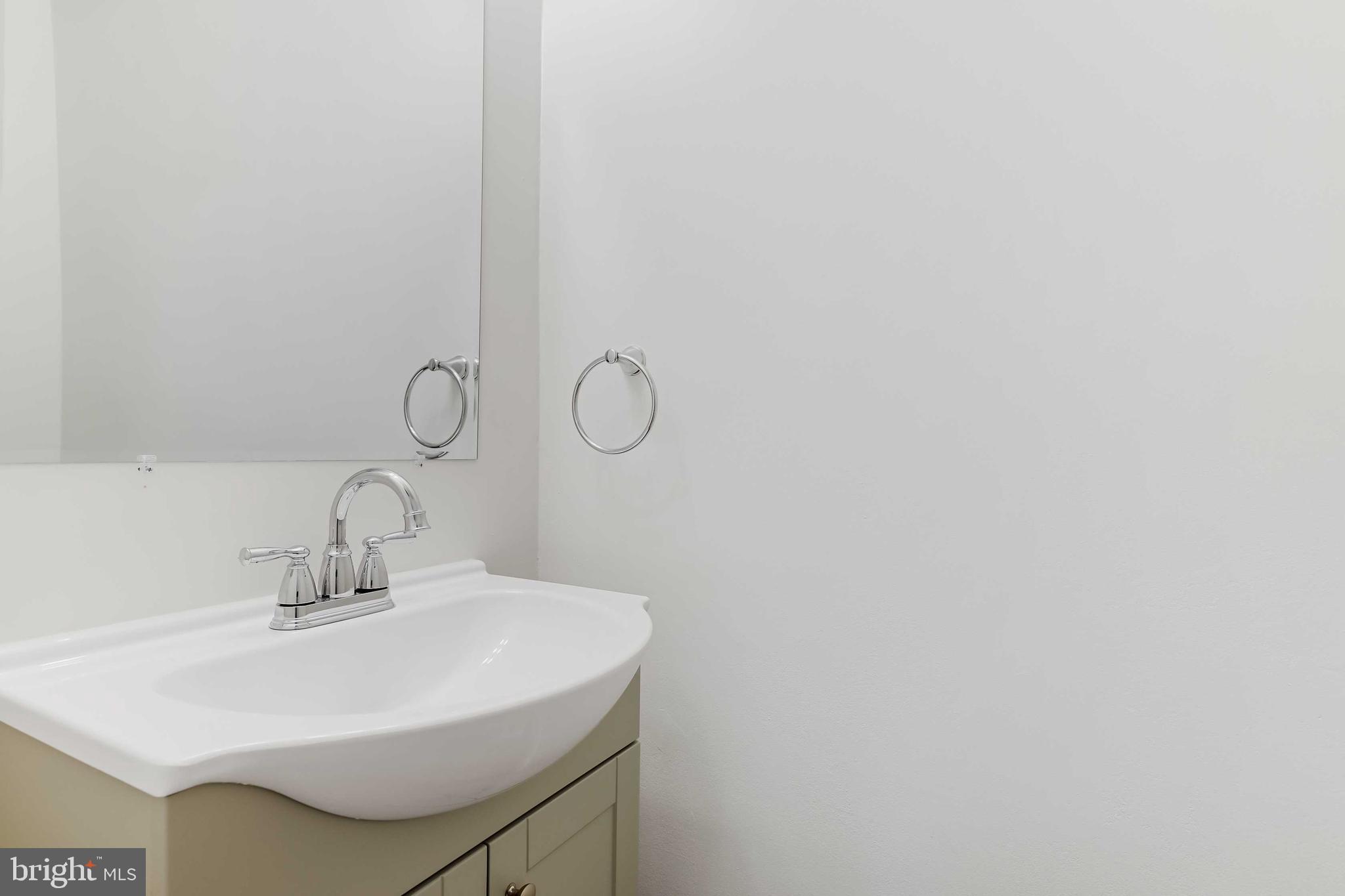 1634 Mt Airy Court Crofton, MD 21114 - Photo 15 of 40 a bathroom with a sink and a mirror