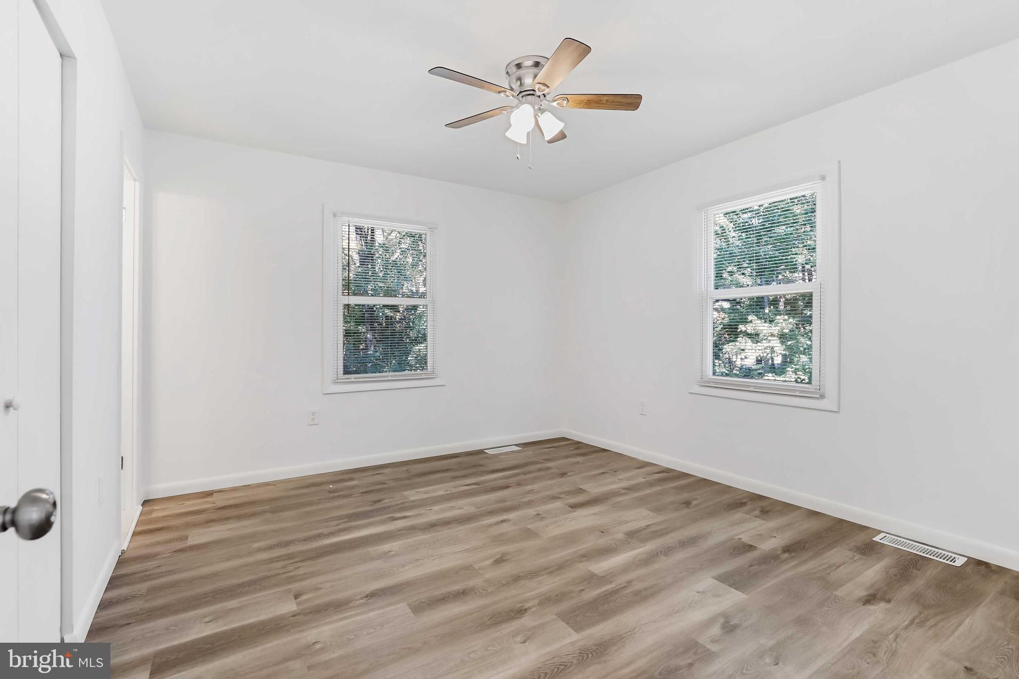 1634 Mt Airy Court Crofton, MD 21114 - Photo 22 of 40 wooden floor in an empty room with a window