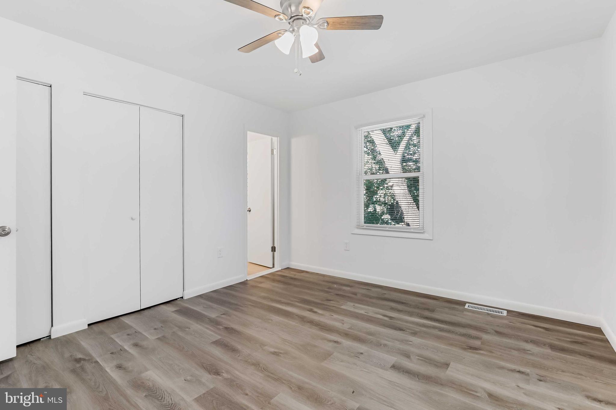 1634 Mt Airy Court Crofton, MD 21114 - Photo 23 of 40 wooden floor in an empty room with a window