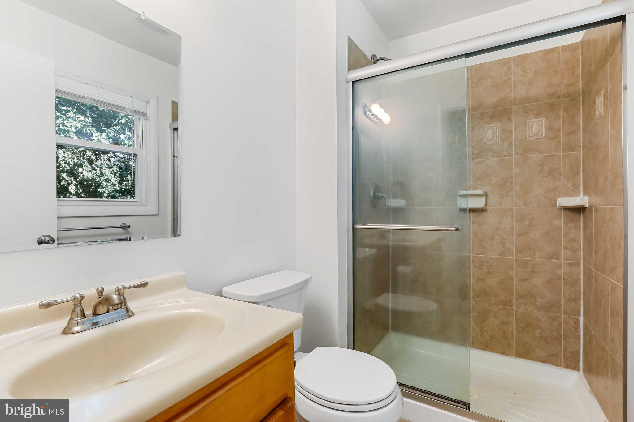 1634 Mt Airy Court Crofton, MD 21114 - Photo 25 of 40 a bathroom with a sink toilet and shower