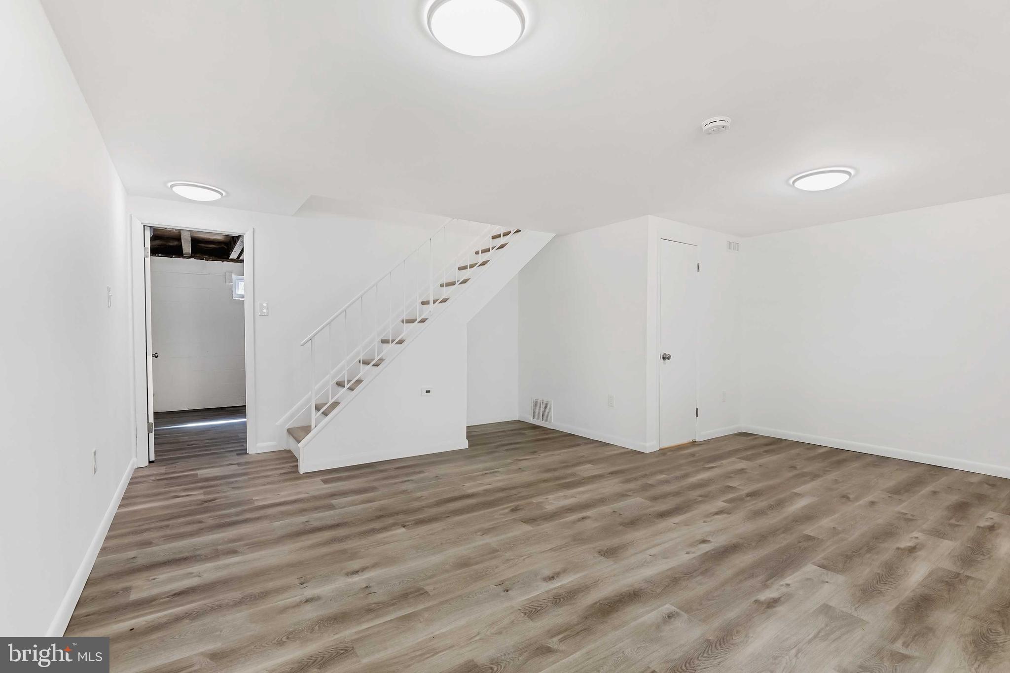 1634 Mt Airy Court Crofton, MD 21114 - Photo 26 of 40 a view of an empty room with wooden floor