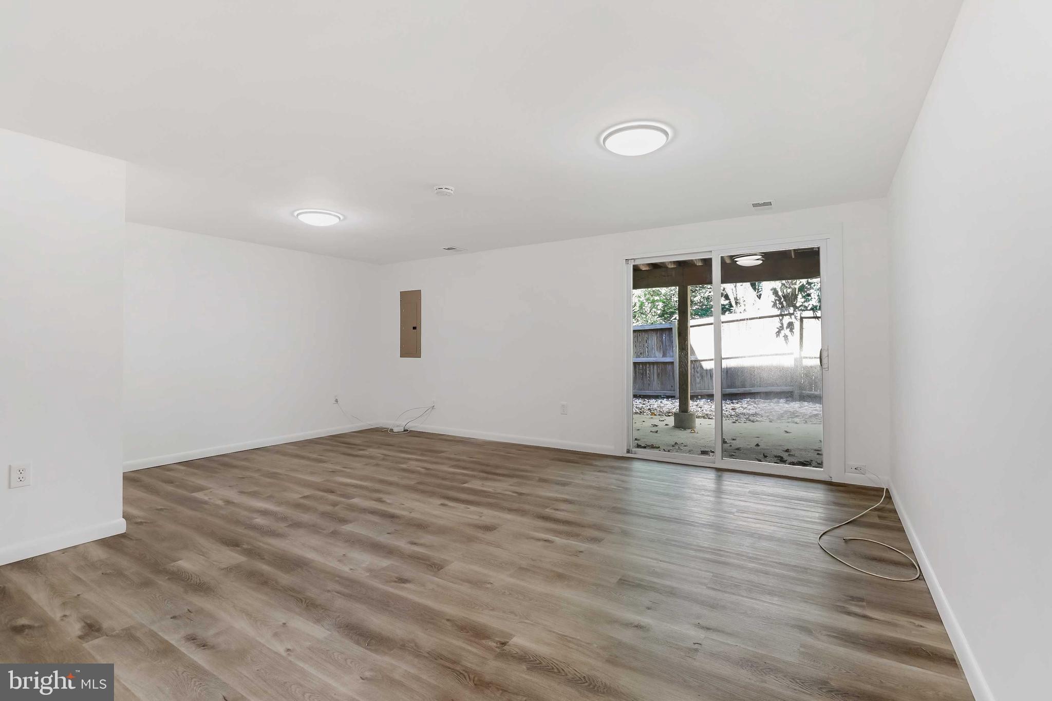 1634 Mt Airy Court Crofton, MD 21114 - Photo 29 of 40 an empty room with wooden floor and windows