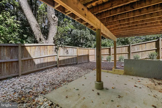 a backyard of a house with barbeque oven table and chairs
