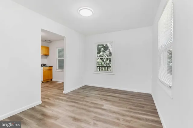 an empty room with wooden floor and closet