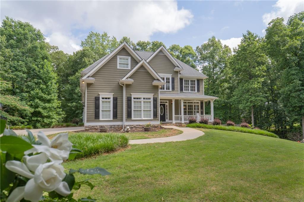 7300 Berea Road Winston, GA 30187 - Photo 1 of 1 a front view of a house with a garden and trees