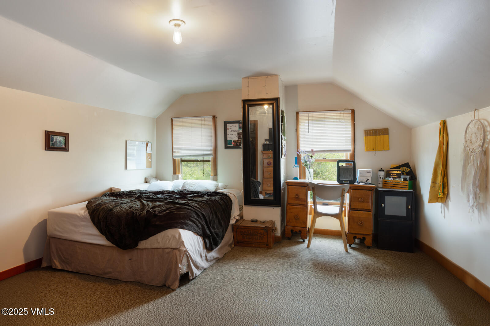 407 Water Street Red Cliff, CO 81649 - Photo 21 of 25 a spacious bedroom with a bed and a couch