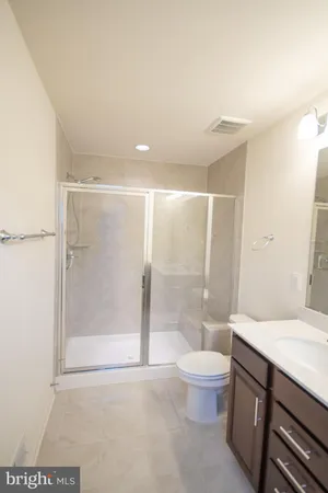 a bathroom with a sink vanity and a mirror