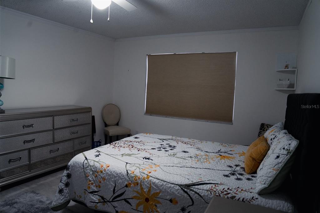 519 Albee Farm Road, Unit 110 Venice, FL 34285 - Photo 13 of 33 a bedroom with a bed and large windows