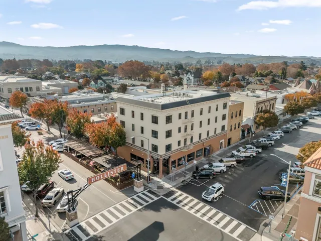 a kitchen with granite countertop white cabinets a sink a window and stainless steel appliances