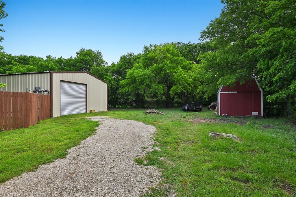 305 South Cockrell Hill Road Ovilla, TX 75154 - Photo 34 of 40 a view of a backyard with barn and large trees