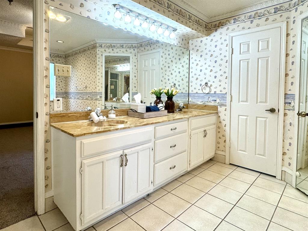 113 Northeast Timber Ridge Drive Burleson, TX 76028 - Photo 26 of 36 Dual Sink Vanity with a marble-finish countertop, and ample storage cabinetry... Door to Private Potty Area on the Right