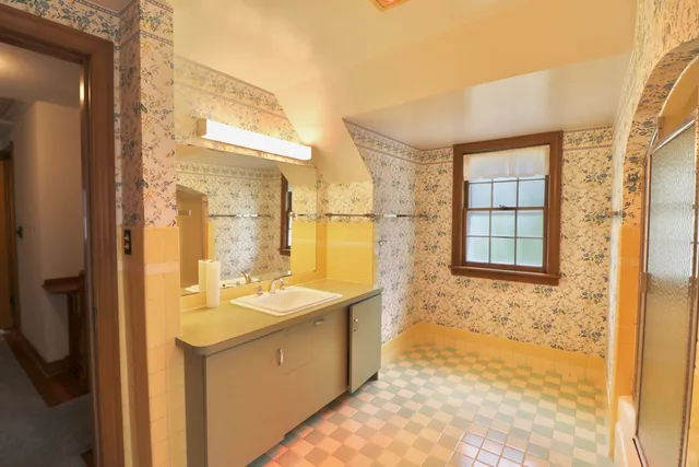 a bathroom with a sink mirror and a bathtub